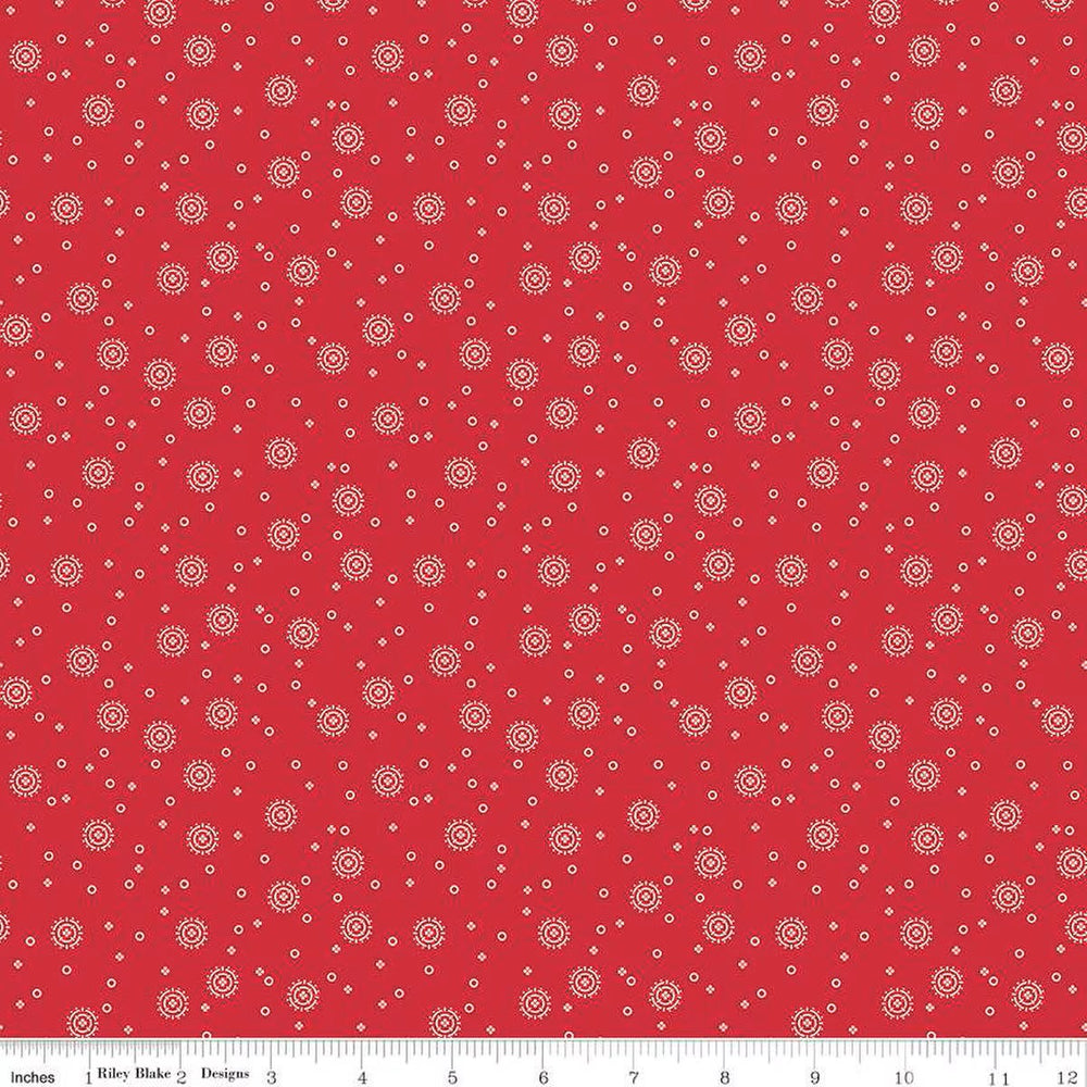 Red Delicious - Cherry Soda Red puuvillakangas, valkoisia täpliä punaisella taustalla.