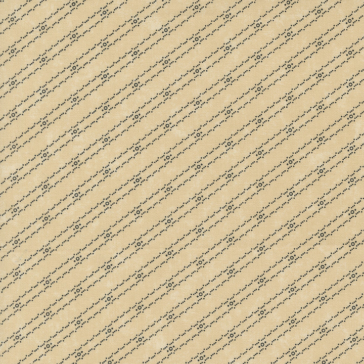 Kansas Troubles Quilters - Blackbird's Nest Bird Tracks Tan puuvillakangas, jossa mustia geometrisia raitakuvioita beigen pohjalla.