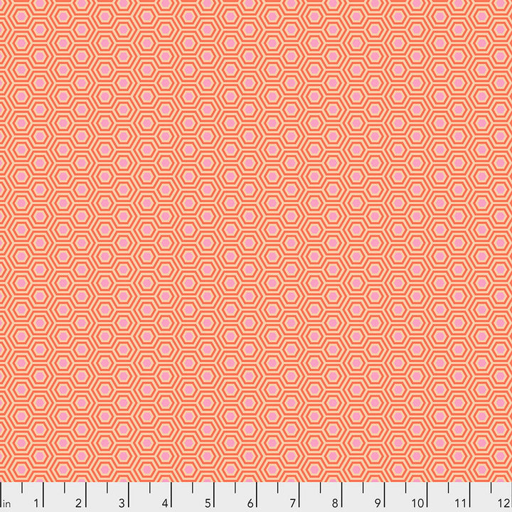 Tula Pink True Colors Hexy Peach Blossom  -kangas, persikan sävyinen pohja pastellisilla hexagon-kuvioilla.