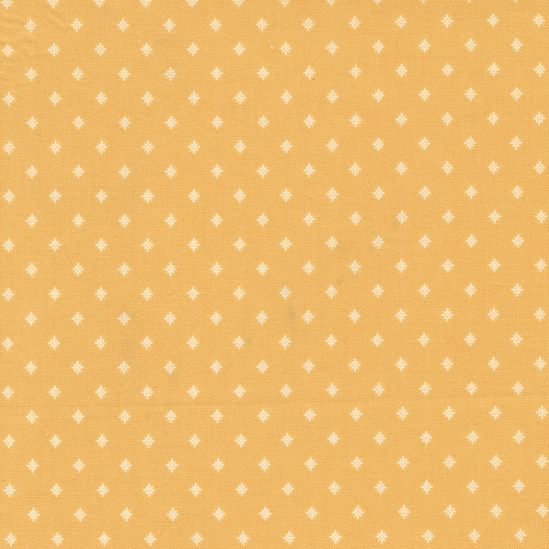 Lähikuva Betsy Chutchian Amelia’s Blues -kokoelman Goldenrod Shifts and Stays -puuvillakankaasta, keltainen täplä kuosi, Moda Fabrics.