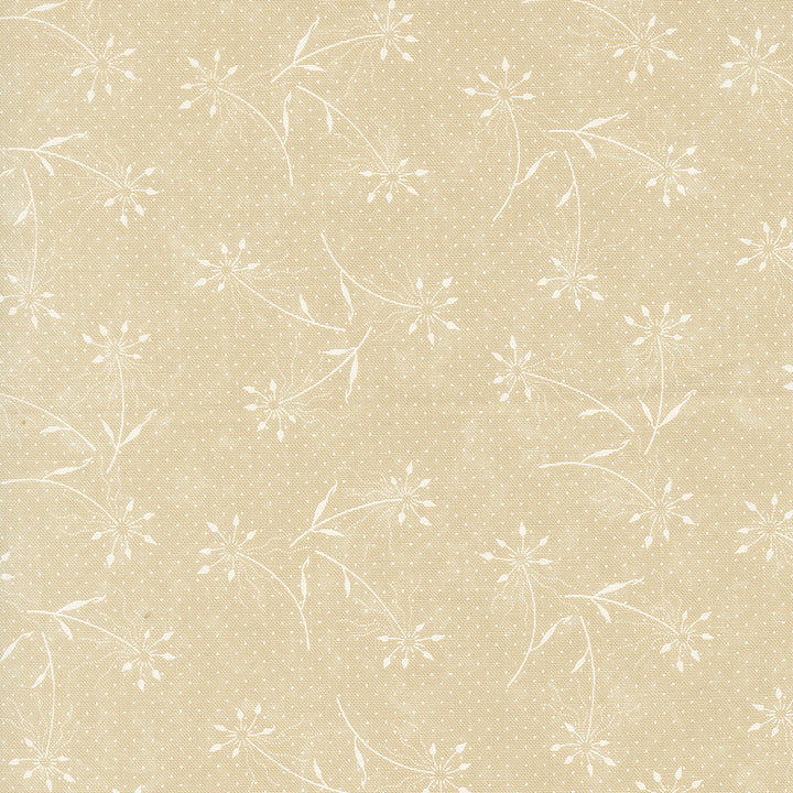 Kansas Troubles Quilters - Blackbird's Nest Dandelions Tan Tonal puuvillakangas, jossa valkoisia voikukkakuvioita ja pieniä pilkkuja lämpimän beigen pohjalla.